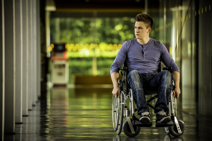 Teenager in wheelchair reflecting